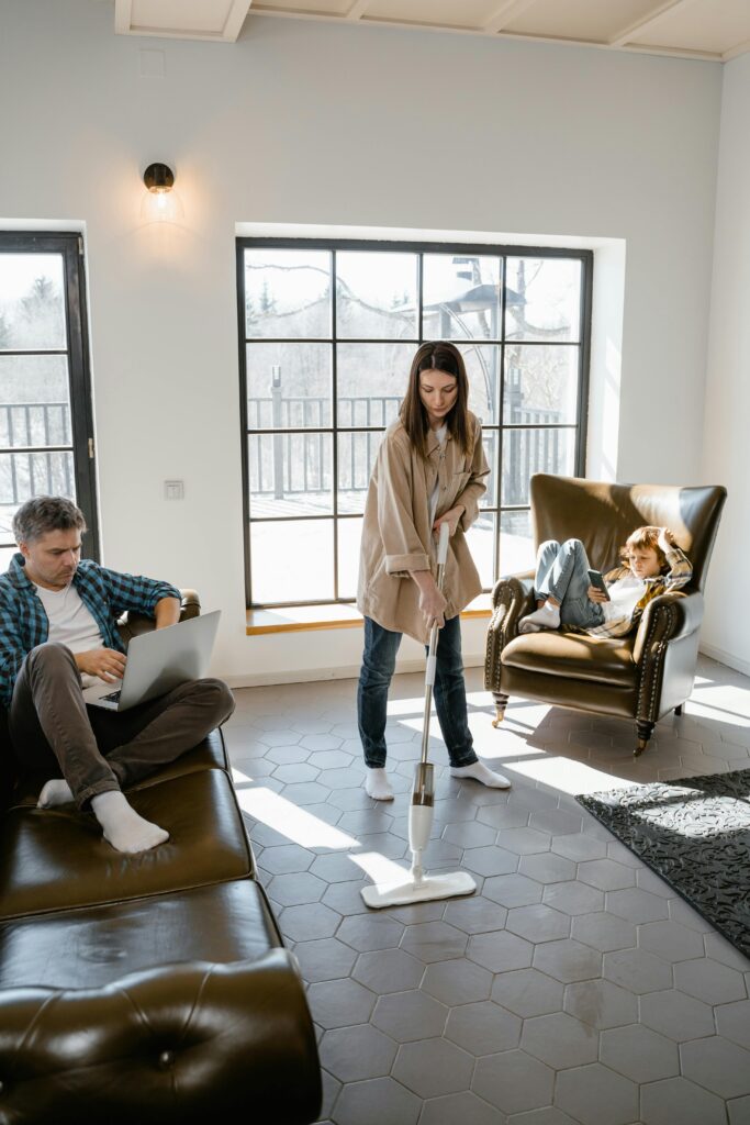 pexels photo 7641259 7641259 A modern family enjoying leisure and cleaning time in their bright living space.